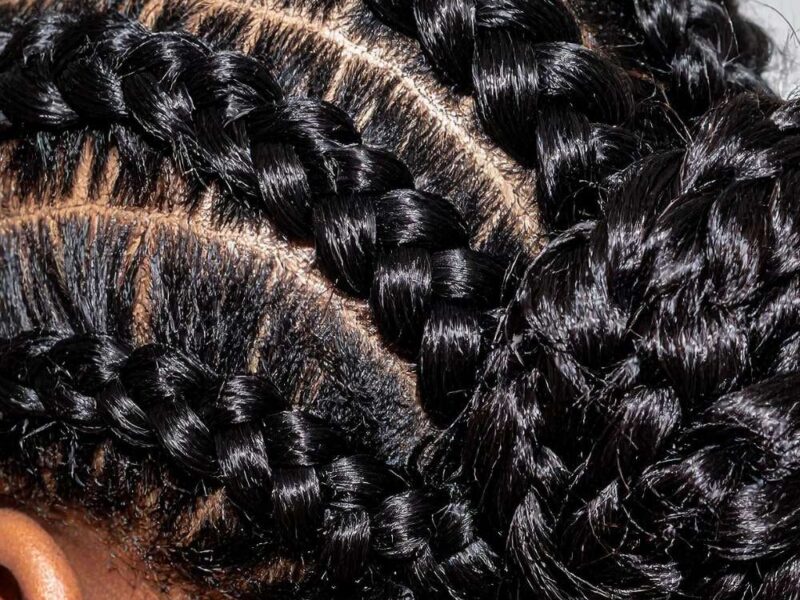 A lady on a cornrow hairstyle