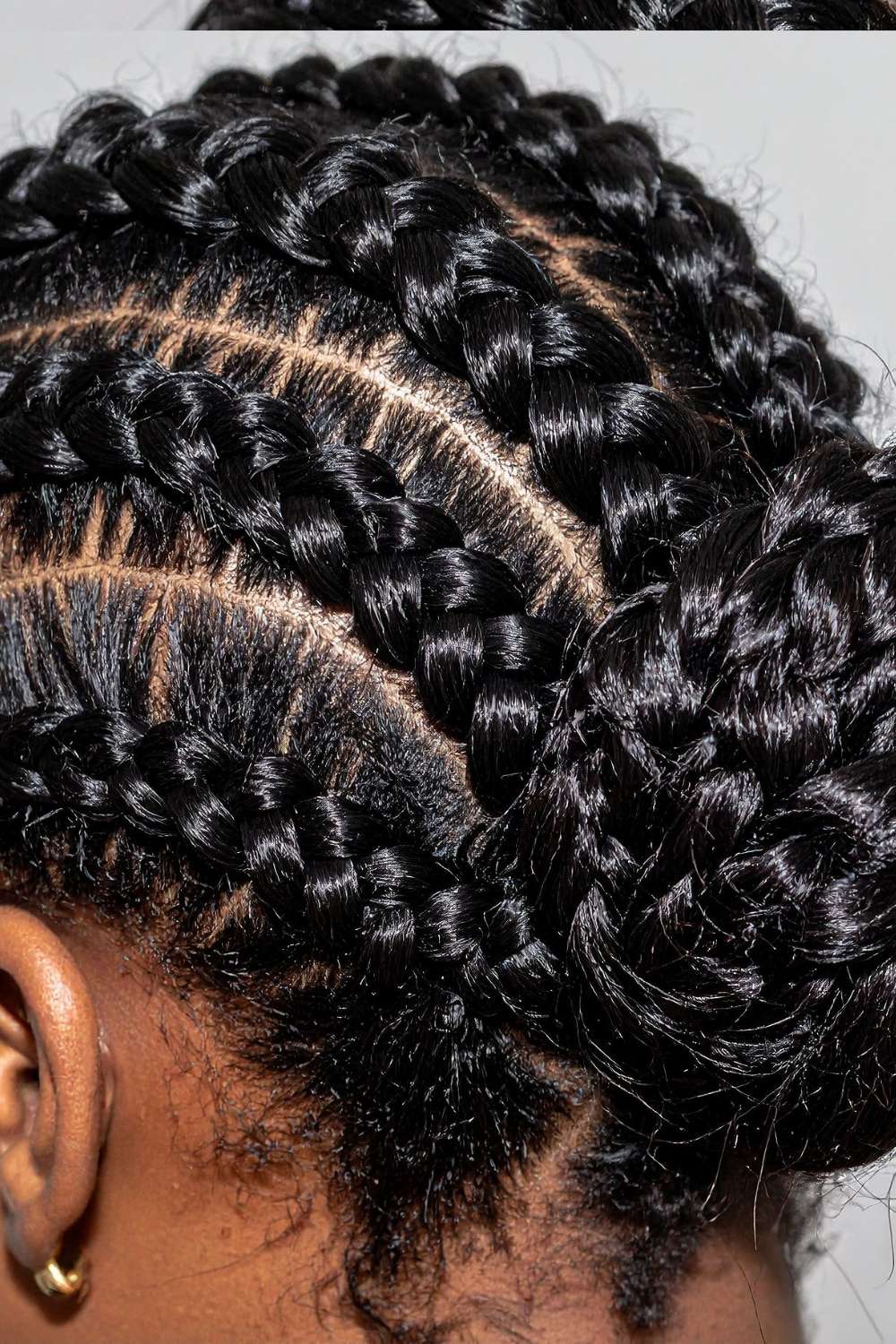 A lady on a cornrow hairstyle