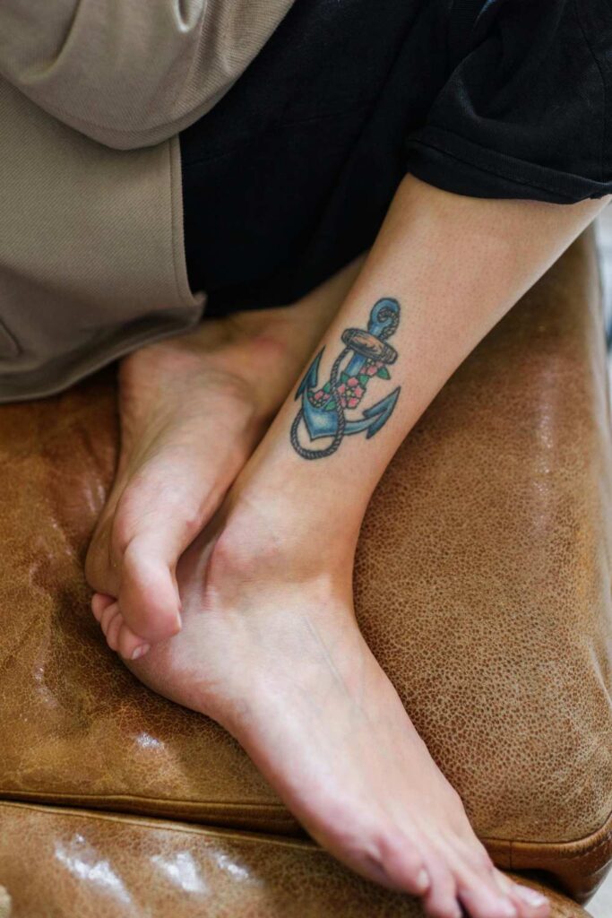 An anchor tattoo designed on a girls leg
