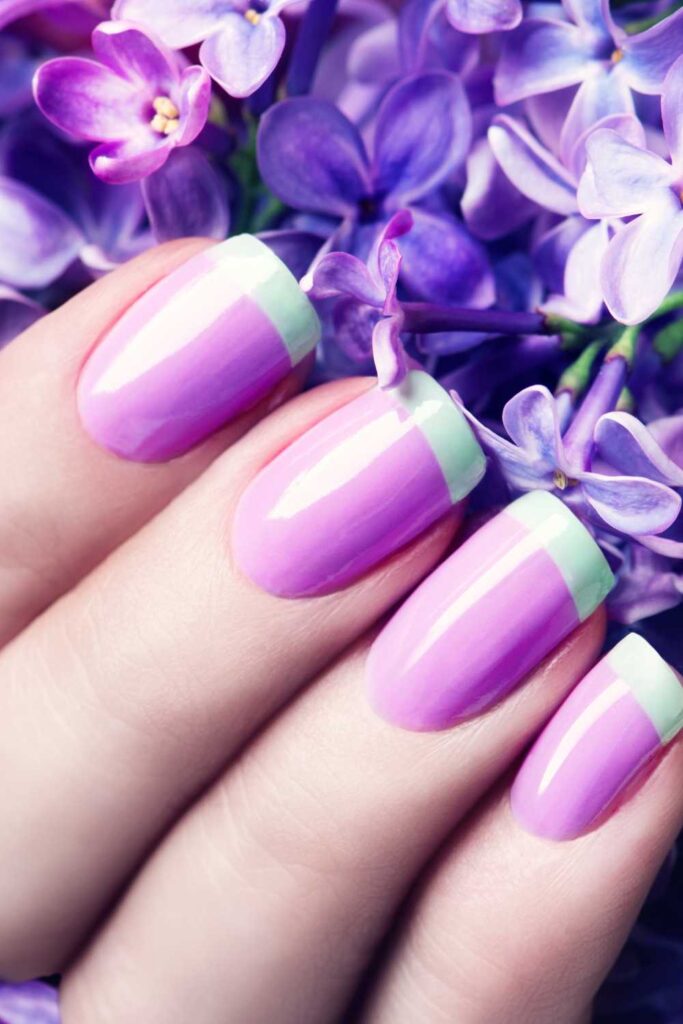 A hand showing a bright pop up nail color design
