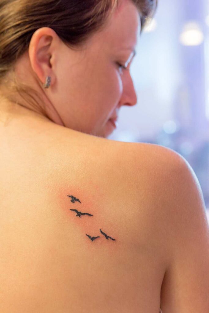 A cute micro tattoo of an eagle designed at a lady's back.

