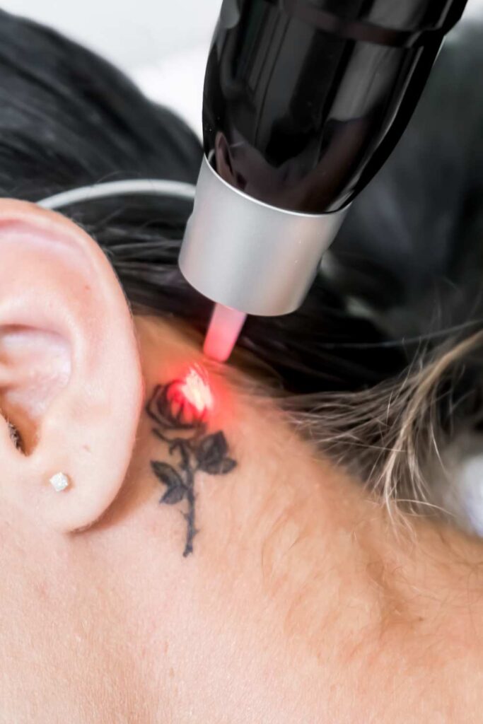 A picture of tiny floral tattoo drown beside the ear
