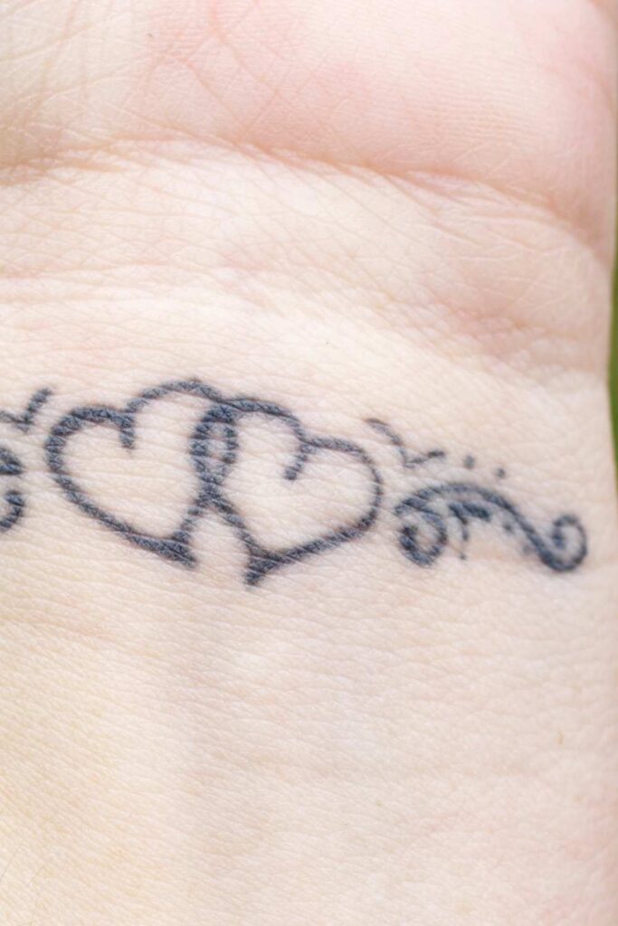 A love tattoo symbol on someone's wrist
