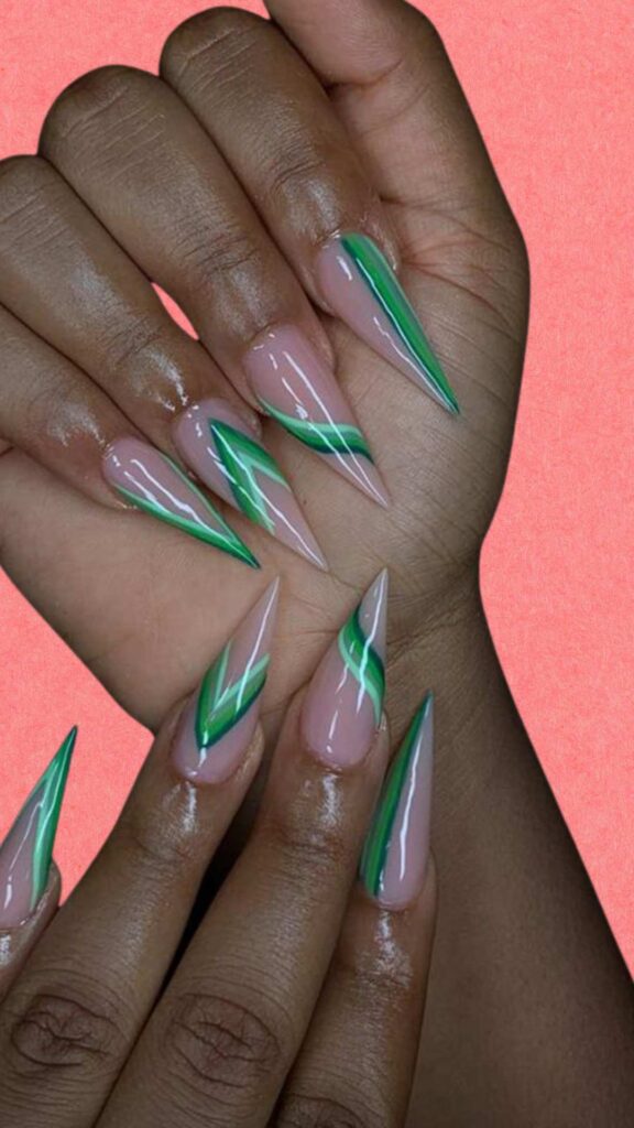 A color combination nails of nude color and green designs
