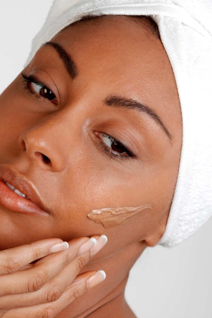 A matte foundation on a lady's face trying to blend in her skin color.