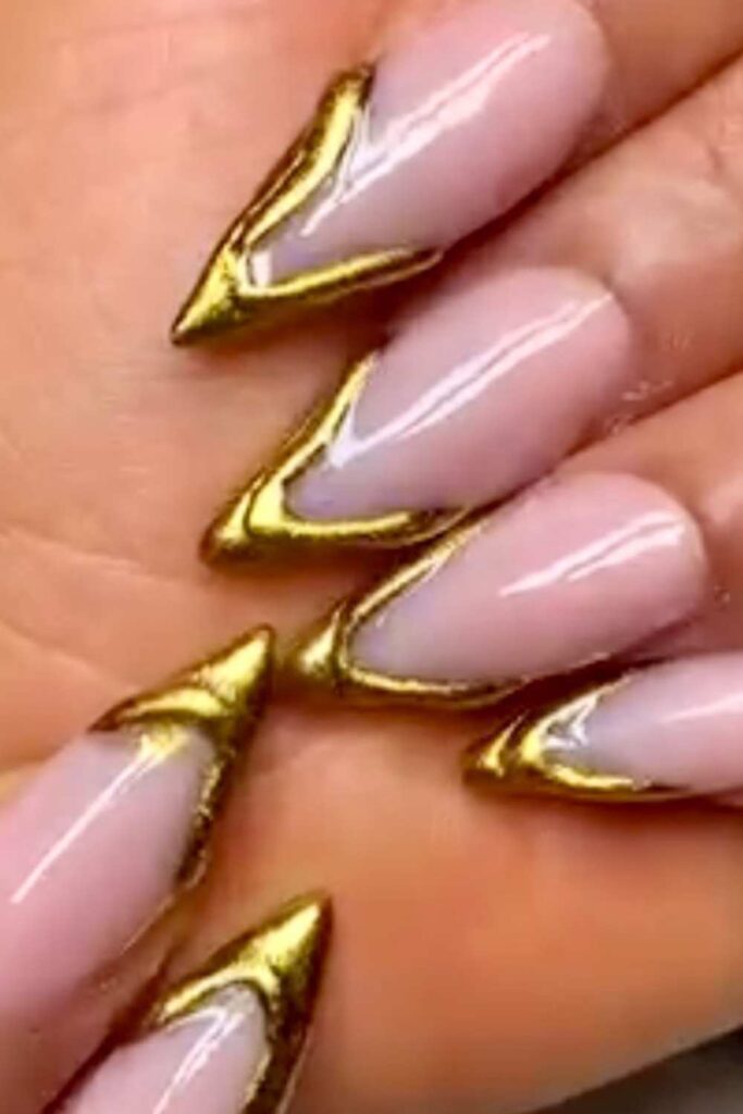 A picture of nude pink nails with a glitter golden color