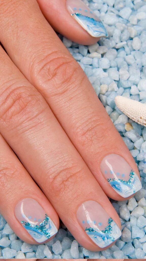 Ocean and beach nail with a nude, blue and white color design