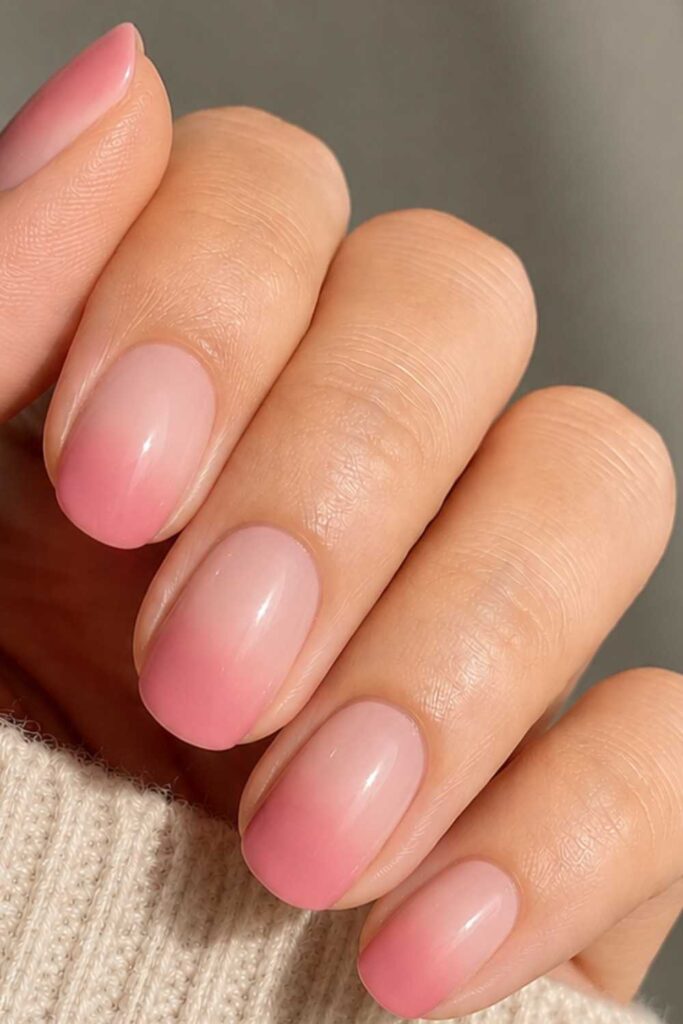 A picture of an ombre pink nails design.