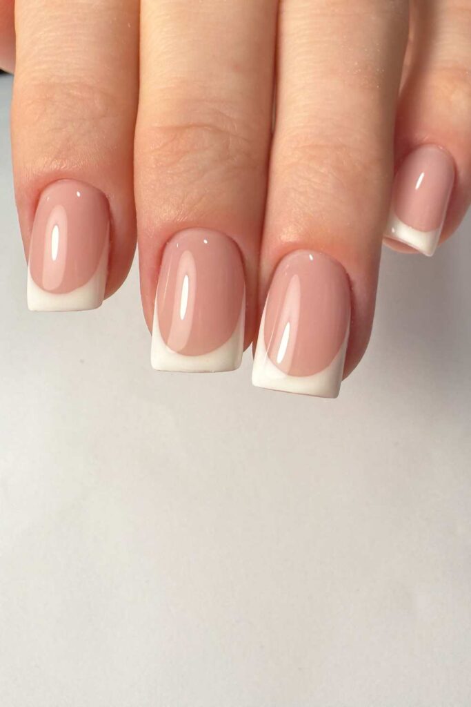 Simple and detailed nail design
with white tips.