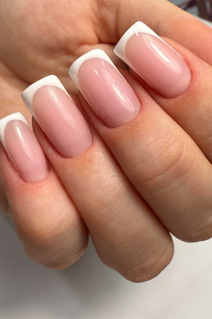 A picture of a pink nails tips design on the hand
