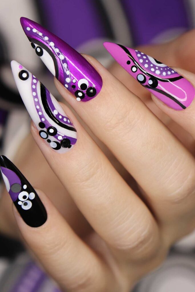 A picture of a purple nails design with spotted white design that looks gorgeous.
