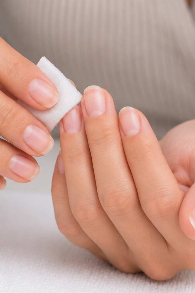 Cleansing the nails using Alcohol or nail dehydrator