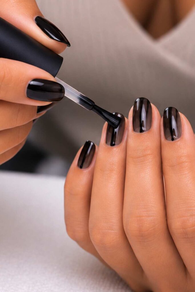 Apply a black nail paint on the nails