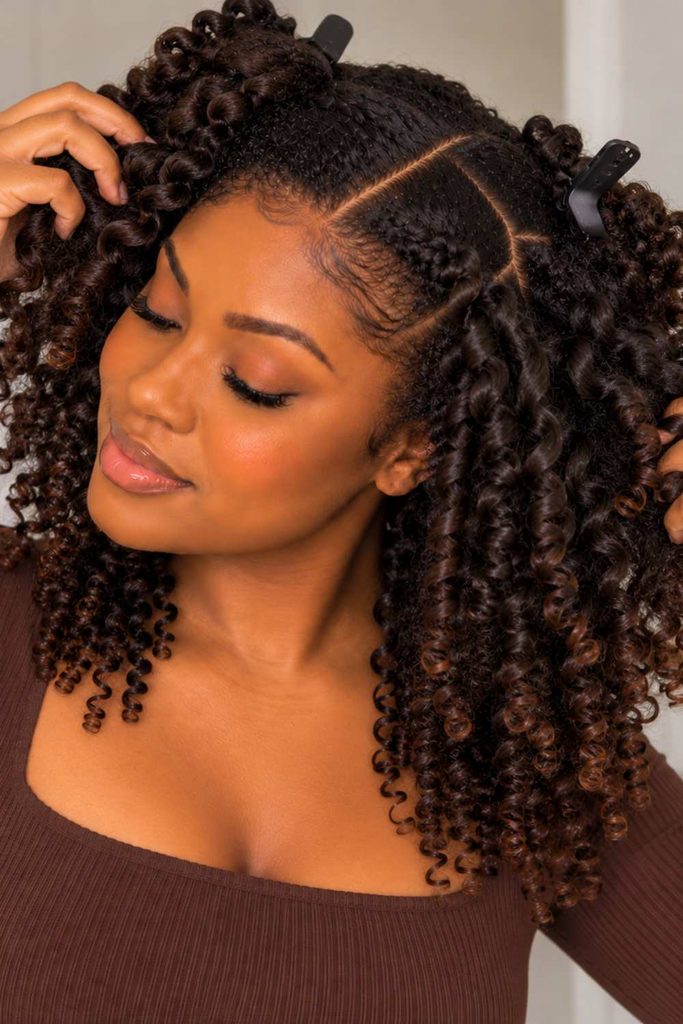 The lady using her hand to add volume to the hair